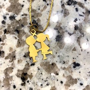 Boy and girl kissing necklace.